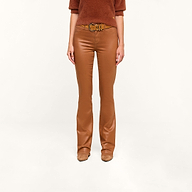 A person wearing a dark java brown sweater, the Selma Coated Bootcut Jean, and tan shoes stands against a plain white background.