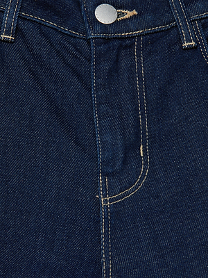 Close-up of the front of L'AGENCE Selma Bootcut Jean in blue denim, highlighting the button, zipper area, and yellow stitching details.