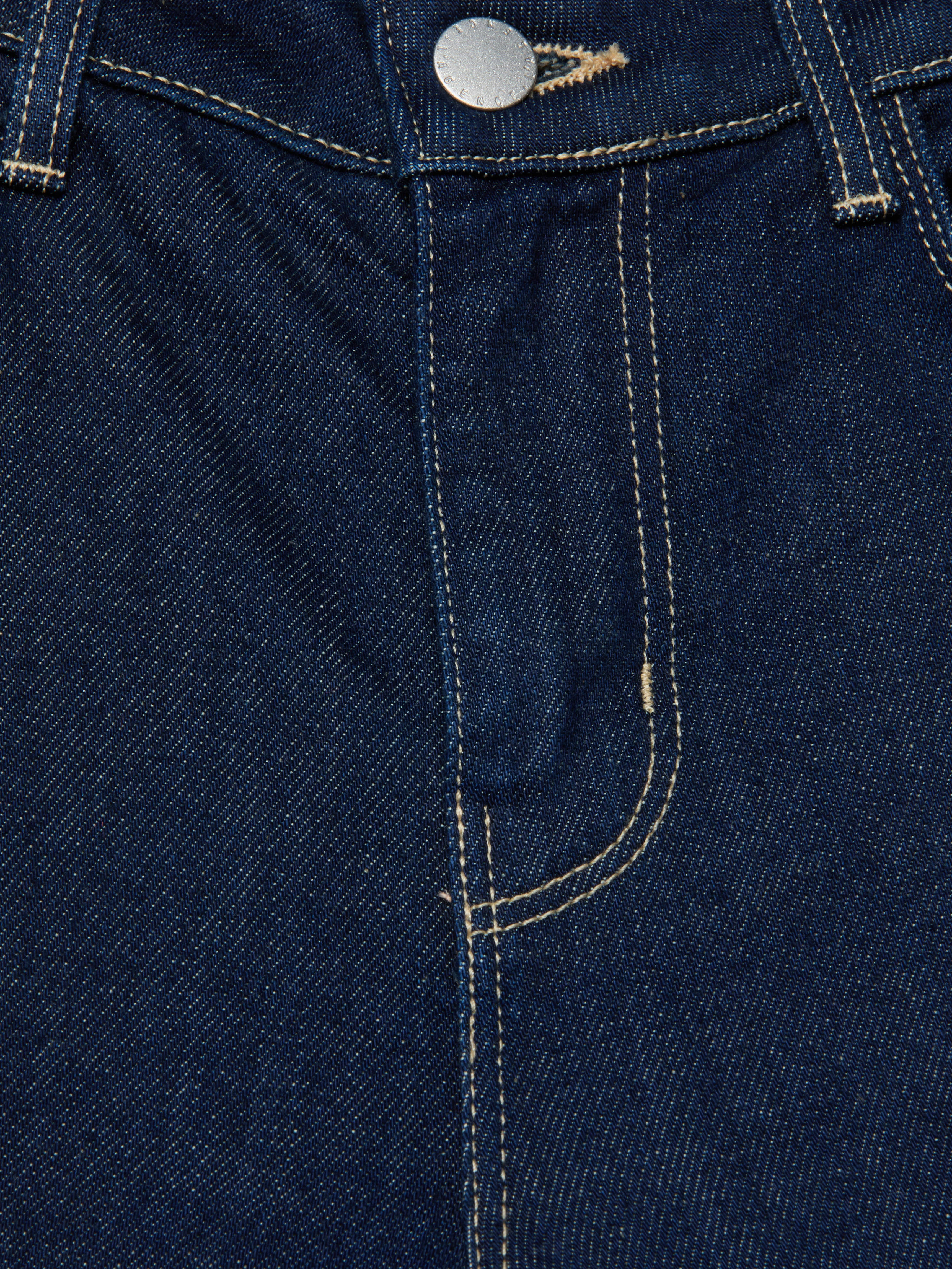 Close-up of the front of the Selma Bootcut Jean in blue stretch denim, highlighting the zipper area, metal button, visible stitching, and belt loops.