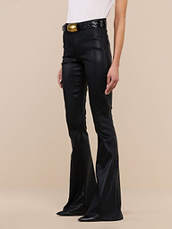 Person wearing the Marty Coated Flare Jean, styled with a black textured belt featuring a large gold buckle and a white top, standing against a plain white background. Only the lower half of their body is visible.