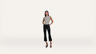 Woman in a sleeveless striped top, black cropped flared pants, and black heels stands against a plain white background, facing forward with hands in pockets.