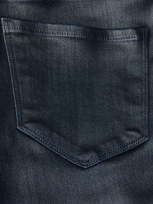 Close-up of the back pocket on the L'AGENCE Kendra Coated Cropped Flare Jean, highlighting the detailed stitching and textured dark blue denim fabric.