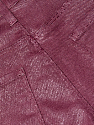 Close-up of the back pockets and seam details on the Kendra Coated Cropped Flare Jean in shiny, textured dark pink denim.