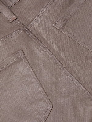 Close-up of L'AGENCE Kendra Coated Cropped Flare Jean in brown denim, showing visible stitching, two angled pockets, and a vertical seam between them.
