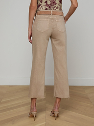 A person wearing Wanda Cropped Wide-Leg Jeans in a neutral tan color and heeled sandals, shown from the back, standing against a plain white background.