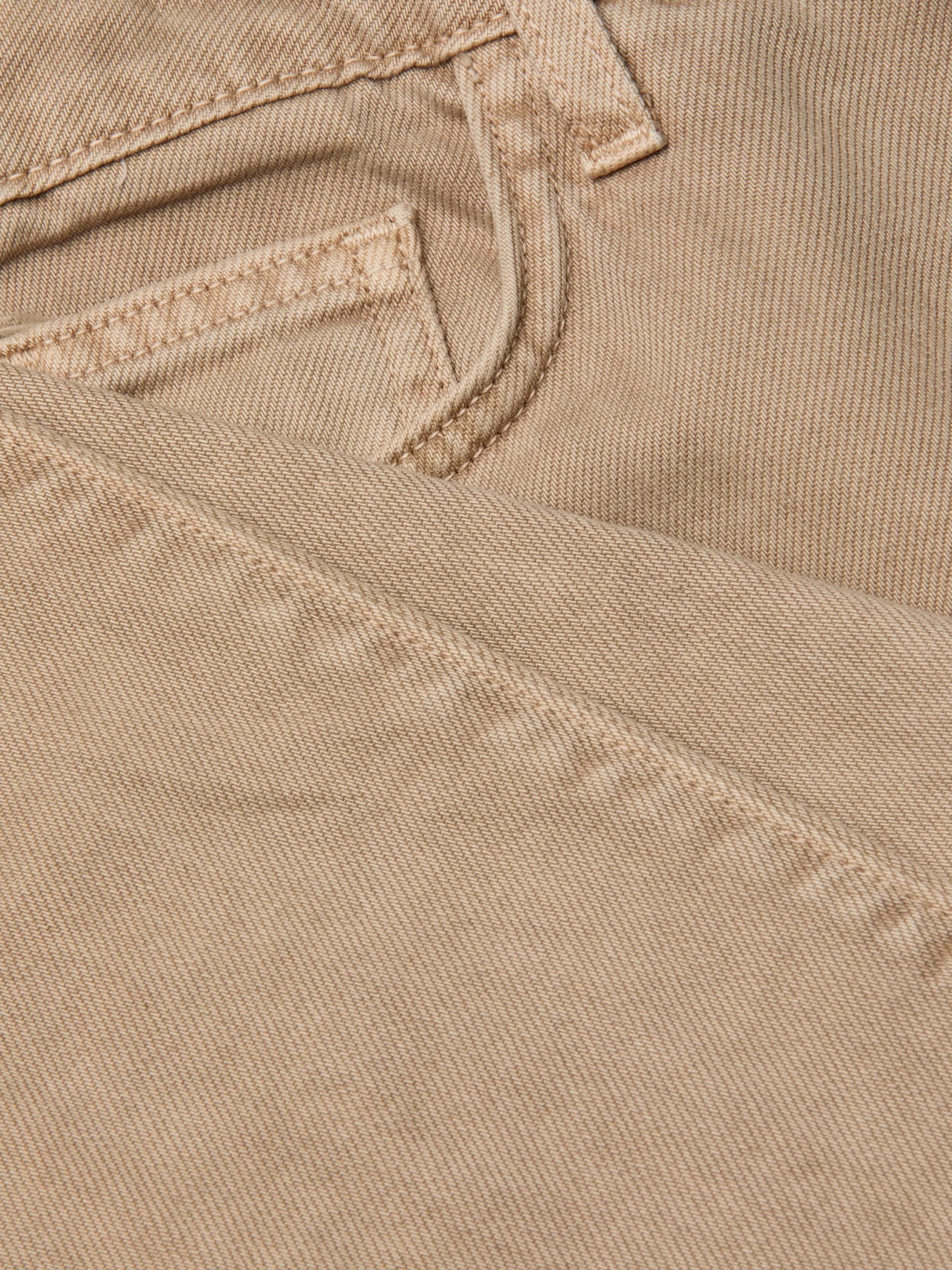 Close-up of the neutral tan denim fabric of the Wanda Cropped Wide-Leg Jean, highlighting a jeans pocket and detailed stitching, with one section of the material folded over the other.