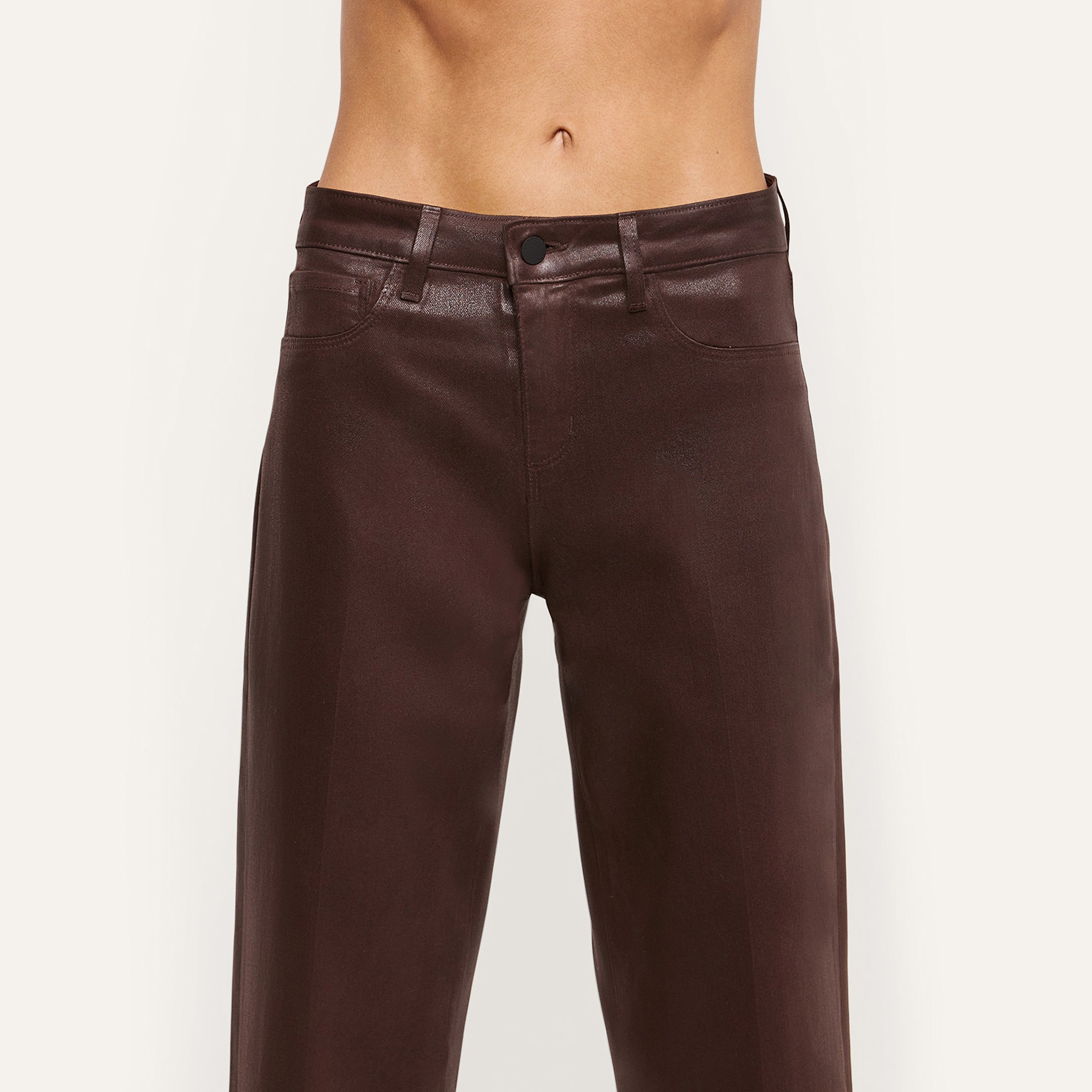 A person wearing the Wanda Coated Cropped Wide-Leg Jean in a high-waisted, dark java brown style; photo shows torso and legs with no shirt visible, set against a plain light background.