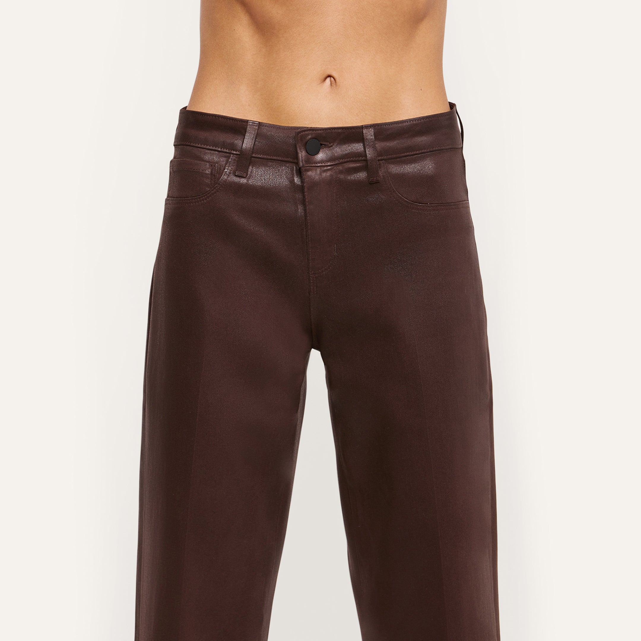 A person wearing the Wanda Coated Cropped Wide-Leg Jean in a high-waisted, dark java brown style; photo shows torso and legs with no shirt visible, set against a plain light background.