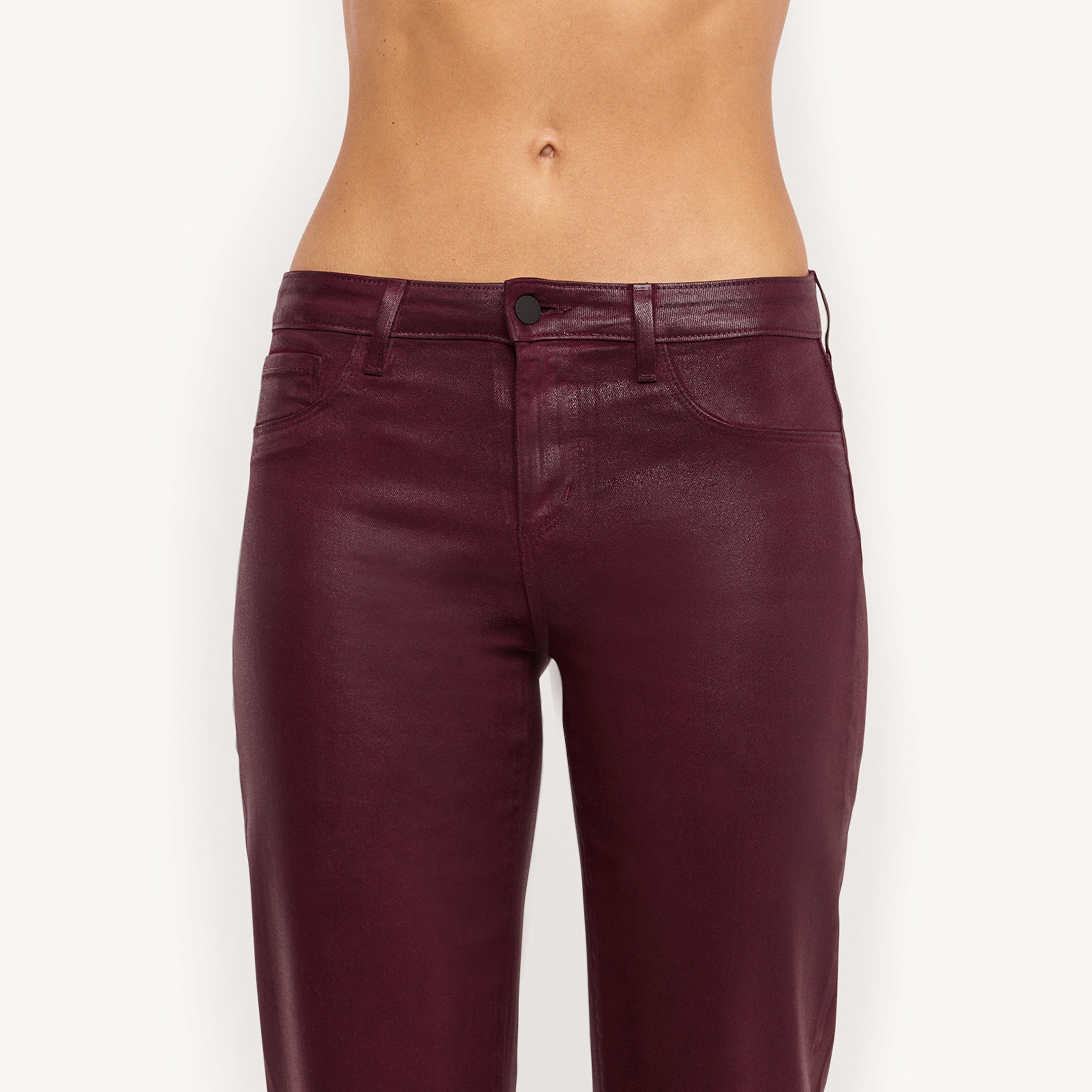 A person wearing the Wanda Coated Cropped Wide-Leg Jean in burgundy is shown from mid-torso to knees against a plain white background.