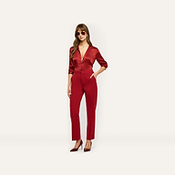 A woman wears a deep red tailored button-down shirt with matching Rebel Trouser high-waisted slim-straight trousers and pointed-toe heels.