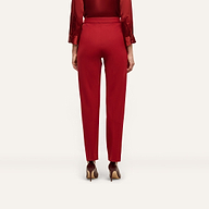 Back view of red Rebel Trouser high-waisted, slim-straight trousers paired with a red button-down shirt and pointed-toe heels in tailored statement stretch twill.