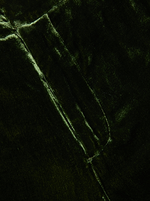 Close-up of L’AGENCE’s Rebel Velvet Trouser in olive, highlighting its soft texture and subtle sheen with visible folds—ideal for crafting sophisticated, straight-leg, high-rise pants.