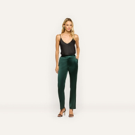 A woman wearing a black spaghetti strap top and forest green Rebel Satin Trouser slim-straight trousers with black heeled sandals.