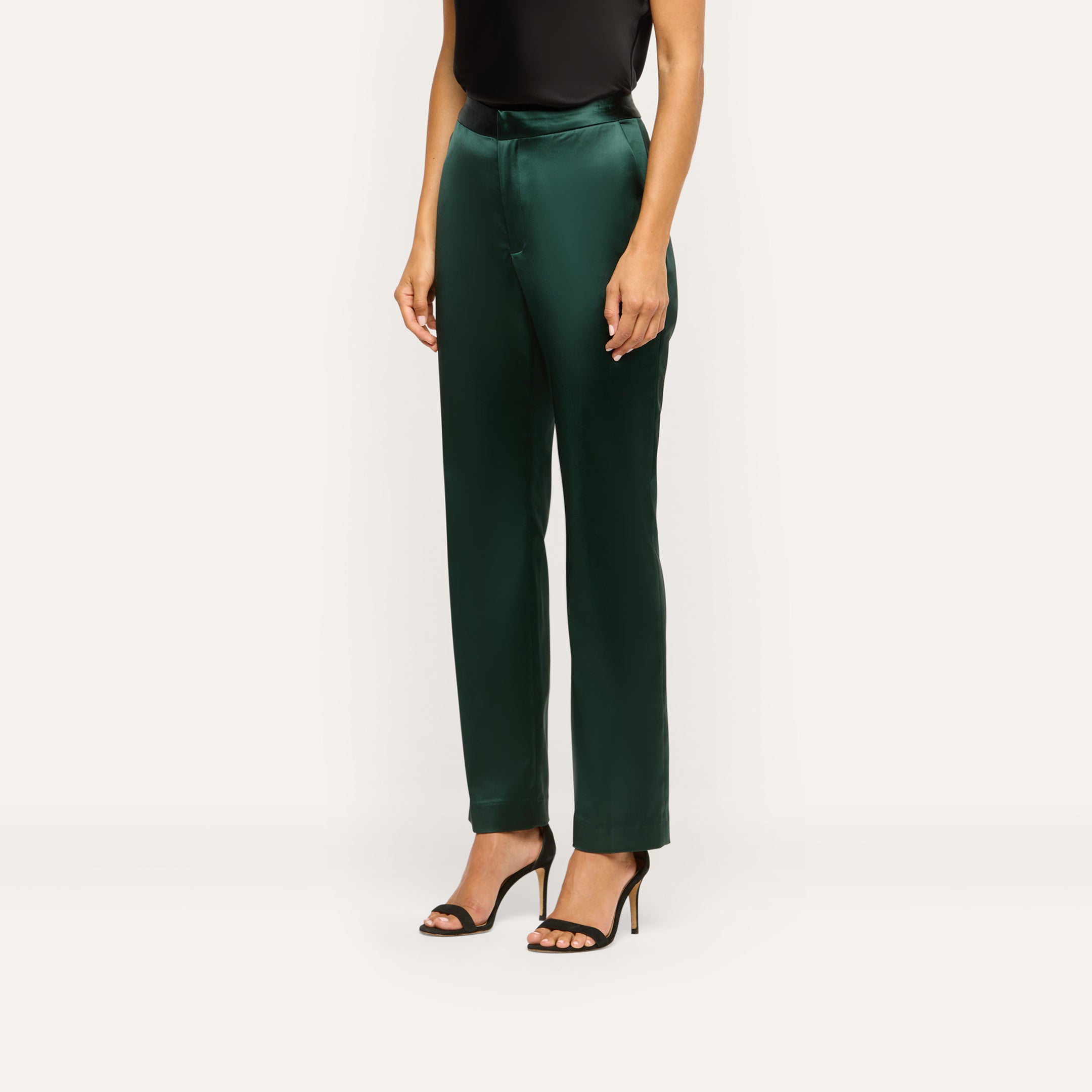 A person wearing dark green Rebel Satin Trousers in a slim-straight fit with black heeled sandals.
