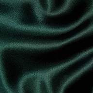 Close-up of the deep green Rebel Satin Trouser, featuring a smooth, glossy texture and soft folds that highlight a tailored statement.