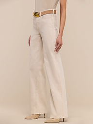 Model showcases the Clayton Wide-Leg Jean with its high-waisted fit, matching belt, and heeled shoes, standing against a plain white background. Only the lower half of the body is visible.