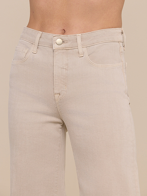Close-up of the Clayton Wide-Leg Jean in light beige, featuring a high rise, tall wide-leg fit, button and zipper closure, belt loops, front pockets, and visible stitching at the waist and upper thigh.