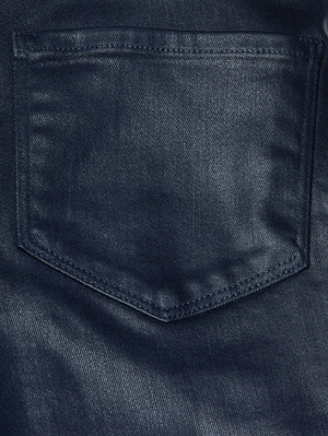 Close-up of the Clayton Coated Wide-Leg Jean by L'AGENCE in dark blue, highlighting the back pocket with visible stitching. The texture and weave of the high-quality coated denim are clearly shown.