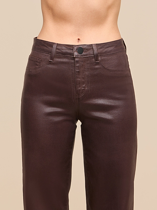 A person wearing the Clayton Coated Wide-Leg Jean in shiny brown coated denim, featuring a high-rise fit and button closure, shown from waist to mid-thigh against a plain beige background.
