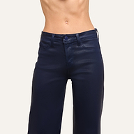 A person wearing Clayton Coated Wide-Leg Jean in dark blue stands against a plain background, displaying their midsection and part of their legs.