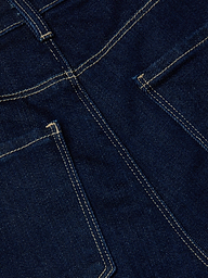 Close-up of the Clayton Wide-Leg Jean in dark wash denim, featuring two pockets and double-stitched yellow seams that showcase the fabric texture and construction details of this high-rise style.
