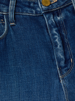 Close-up of the L'AGENCE Clayton Wide-Leg Jean highlights its blue denim fabric, waistband, belt loop, metal button, zipper fly, and stitched seams with a slightly faded texture and visible stitching.