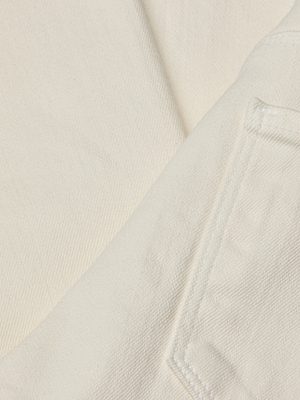 Close-up of cream-colored denim with fine diagonal weave and back pocket stitching—crafted for our Alicent Wide-Leg Jean in a versatile sneaker length.