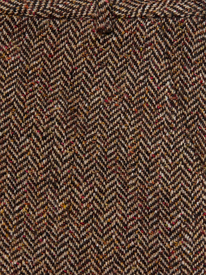 Close-up of the Livvy Straight-Leg Trouser by L'AGENCE, made from Italian recycled wool in a brown herringbone tweed with diagonal lines and colorful flecks woven throughout.