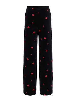 The Livvy Velvet Trouser features a high waist, wide legs, and black velvet fabric adorned with scattered small red rose embroidery.