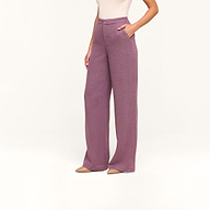 Woman wearing Livvy Straight-Leg Trouser in high rise purple herringbone with hands in pockets, paired with a sleeveless beige top and beige pointed-toe shoes, standing against a plain white background.