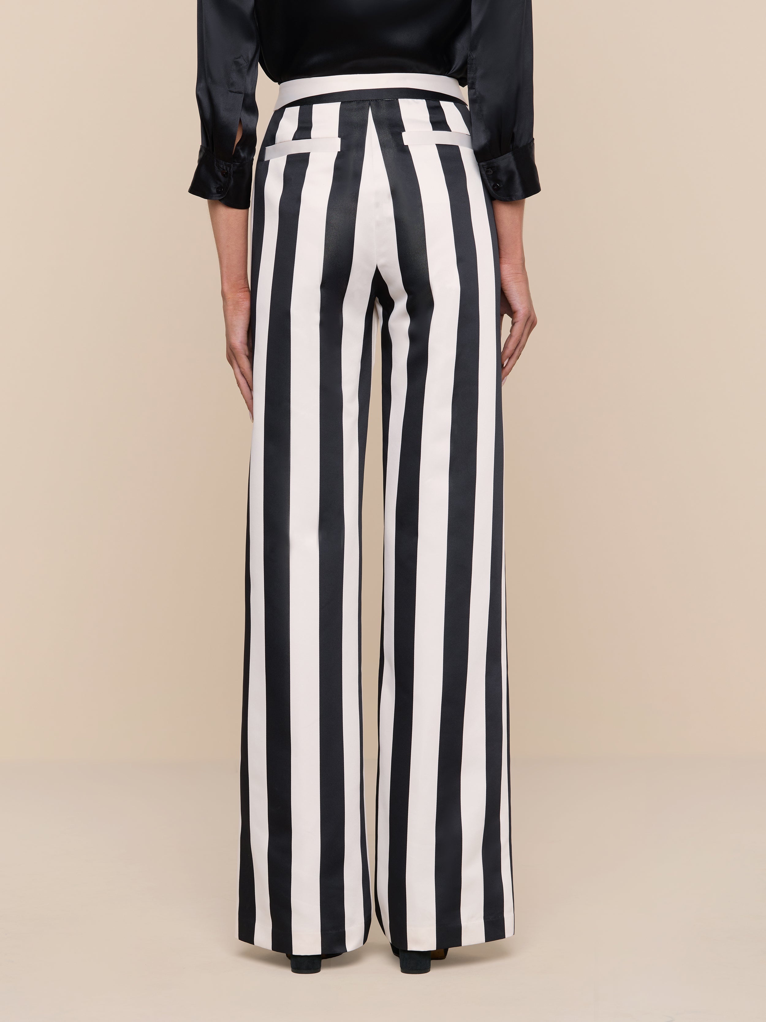 A person is wearing the Livvy Satin Straight-Leg Trouser and a black long-sleeve top, standing against a plain white background, viewed from the back.