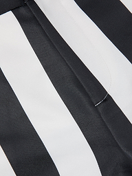 Close-up of black and white striped fabric with a seam and visible stitching, likely part of the Livvy Satin Straight-Leg Trouser.