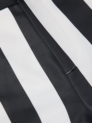 Close-up of fabric from the Livvy Satin Straight-Leg Trouser, showing vertical black and white stripes with a visible seam and slight fold.