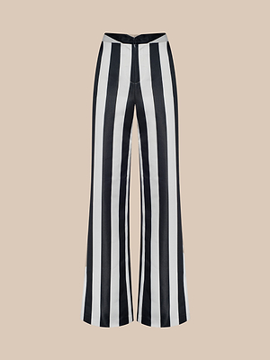 The Livvy Satin Straight-Leg Trouser features bold vertical black and white stripes and is displayed against a plain beige background.