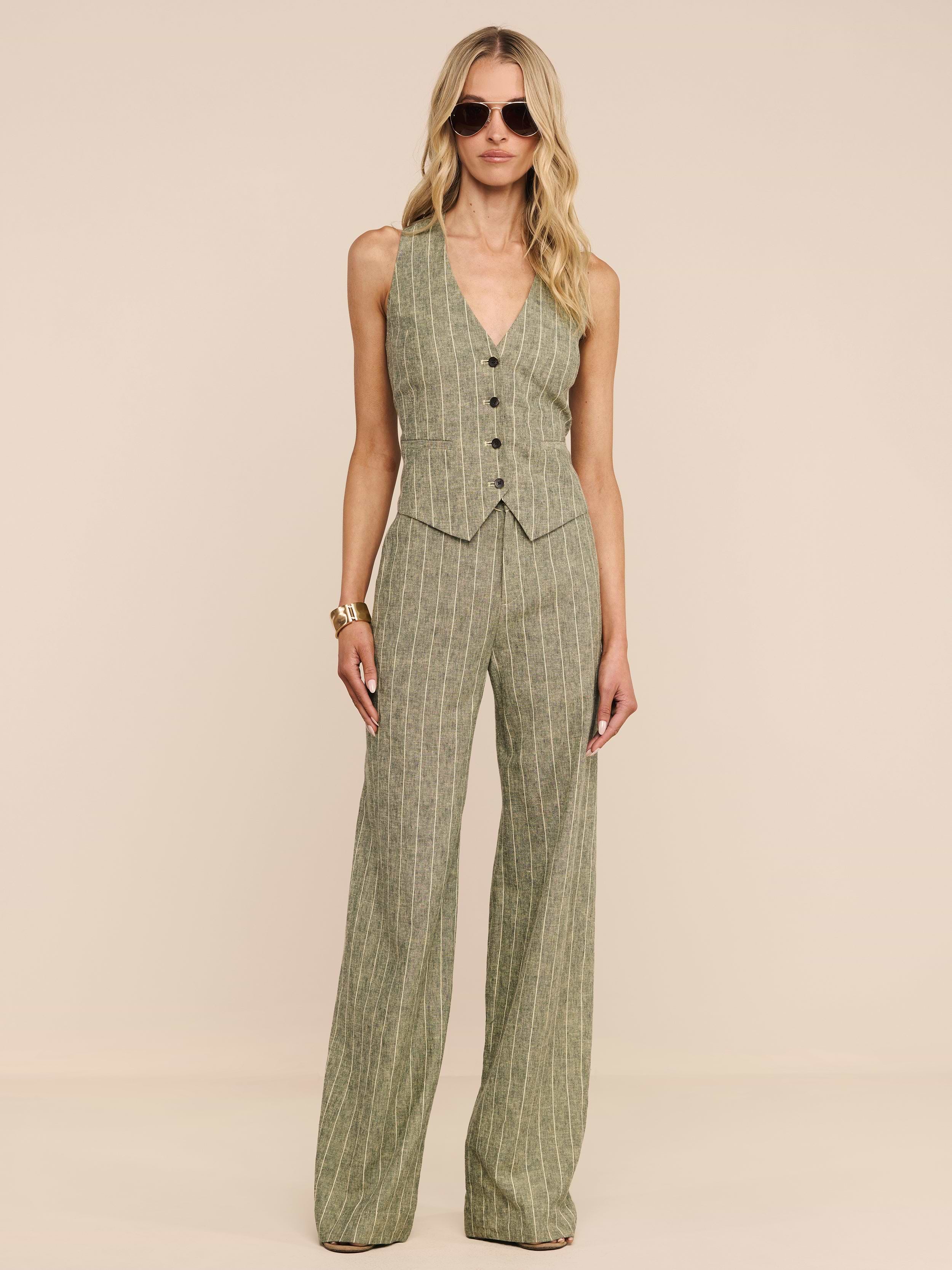 A woman wearing sunglasses, a sleeveless pinstriped vest, and the Livvy Linen-Blend Trouser stands against a plain white background.