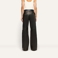 Back view of a person wearing a white tank top and the white Livvy Leather Trouser, featuring a lightweight lambskin leather wide-leg fit.