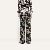 Back view of the Livvy Silk Straight-Leg Trouser in 100 silk featuring a black and white magazine print of faces and text.