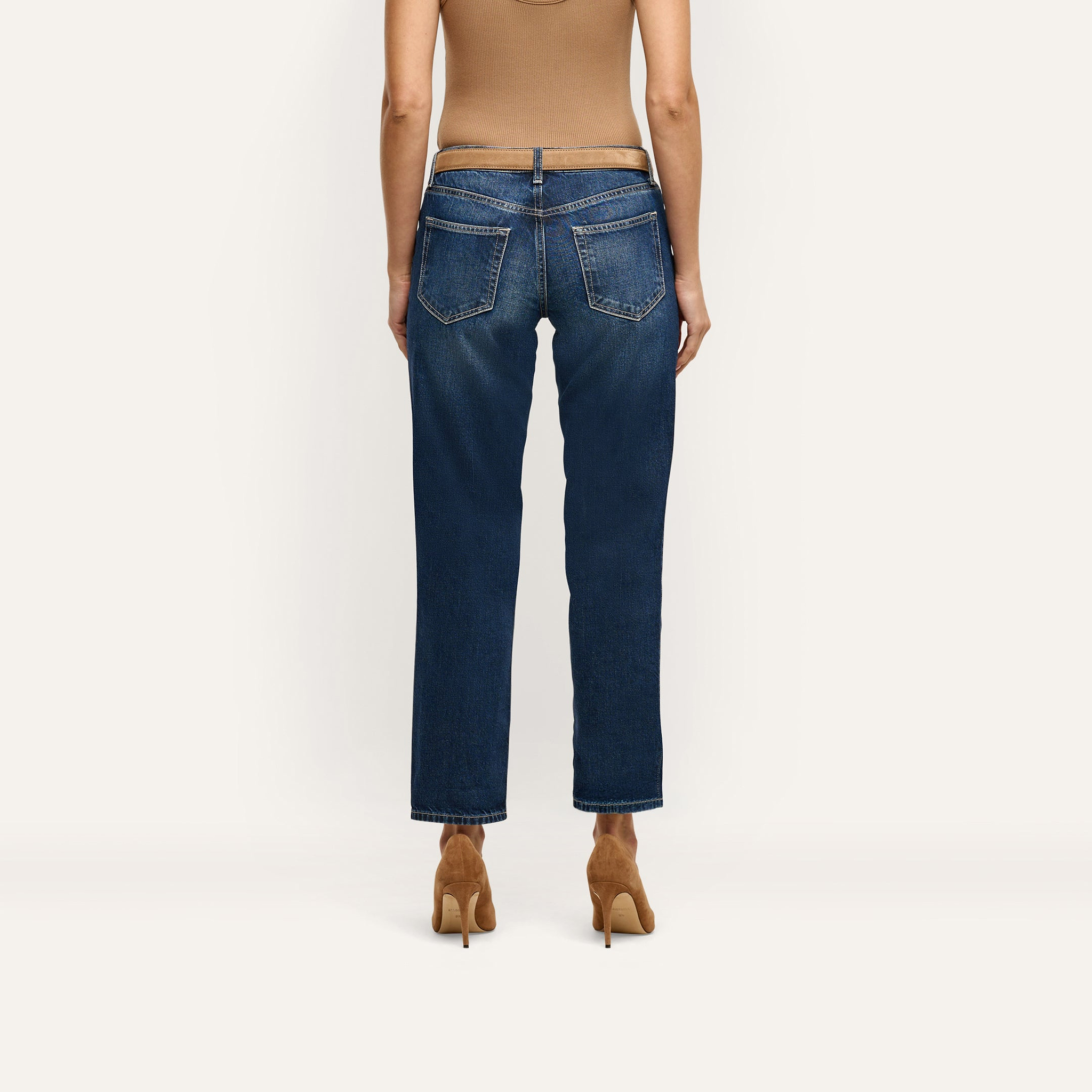 Back view of Nevia Slouchy Straight-Leg Jean in an indigo wash, styled with a tan belt and brown stiletto heels.