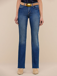 A person wearing Sneeki Low-Rise Straight-Leg Jeans in blue, paired with a brown belt and beige shoes, is standing against a plain white background. Only the lower half of the body is visible.