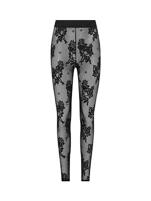 The Josiane Floral Lace Legging features black and white sheer lace with a floral pattern, fitted waistband, and full-length legs, offering a stylish look against a plain white background.