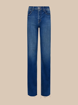 The Scottie Wide-Leg Jean in blue vintage-wash denim features a classic five-pocket design and frayed hem, shown against a plain beige background.