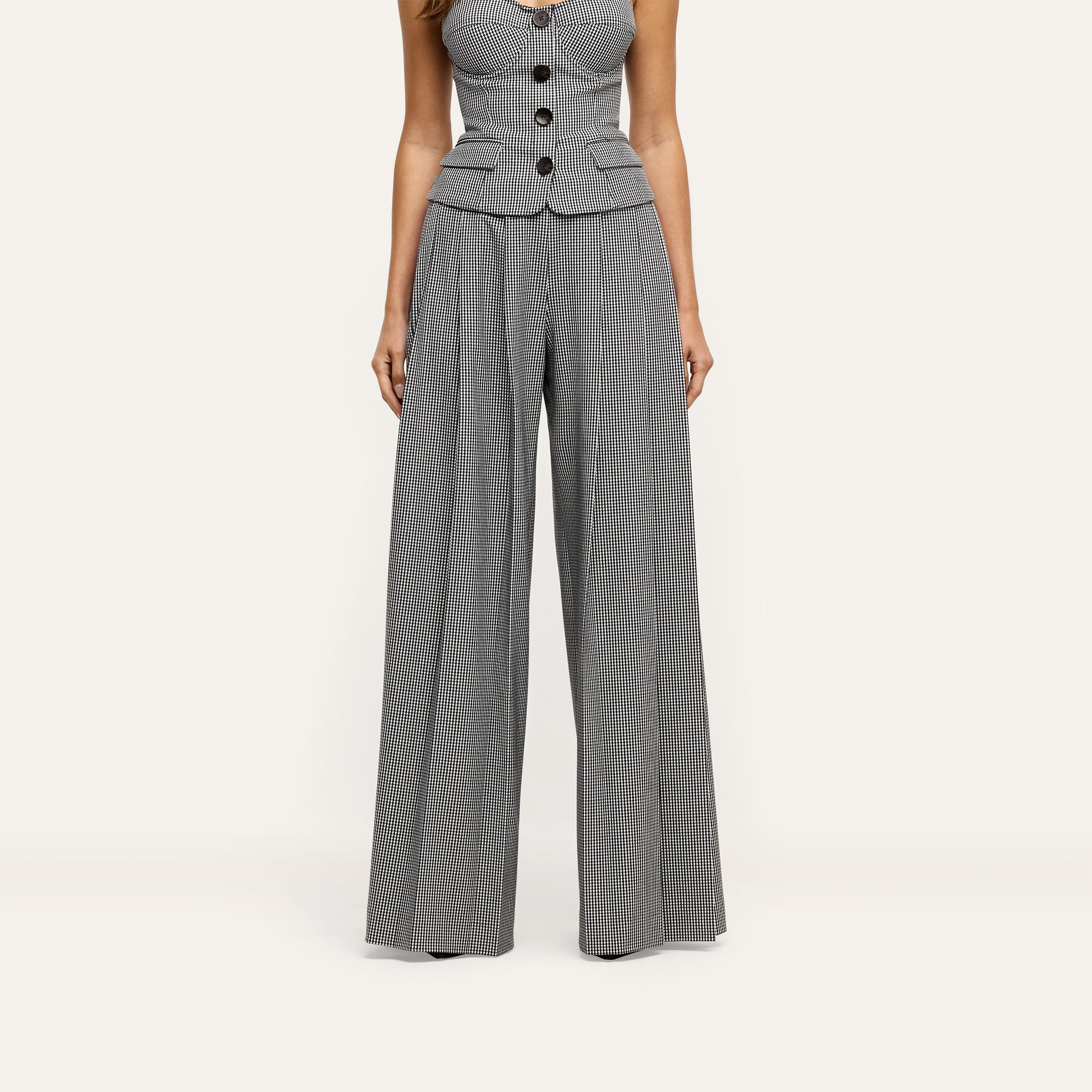 Nova Pleated Wide-Leg Pant in a high-waisted, wide-leg cut featuring a black and white gingham suiting fabric.