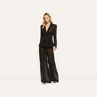 A model wears a sheer black long-sleeved blazer with matching Allanah Sheer Trouser wide-leg chiffon trousers.