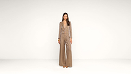 A woman stands against a plain white background, wearing a tan wide-leg pantsuit with a matching blazer and brown shoes. She has long straight hair and a neutral expression, with her arms relaxed at her sides.
