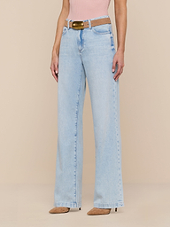 A person wearing the Scottie Wide-Leg Jean in a light wash, styled with a brown belt, a pink top, and beige pointed-toe heels stands against a plain white background.