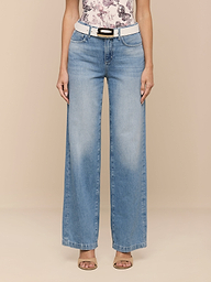 Wearing the Scottie Wide-Leg Jean, a person stands against a plain white background, styled with a white belt, a floral top, and open-toe heels.