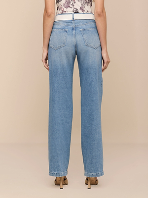 A person faces away, wearing Scottie Wide-Leg Jeans—high-rise, all-cotton denim with back pockets and a floral sleeveless top. The relaxed, straight-leg fit pairs with beige heeled shoes for a chic, casual style.