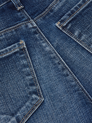 Close-up of the back pockets and seams on the Scottie Wide-Leg Jean, highlighting detailed stitching, classic stretch denim, and a faded blue fabric texture.