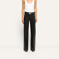 A person wearing a white tank top and Scottie Coated Wide-Leg Jean in black, styled as a high-rise, wide-leg fit with a belt.
