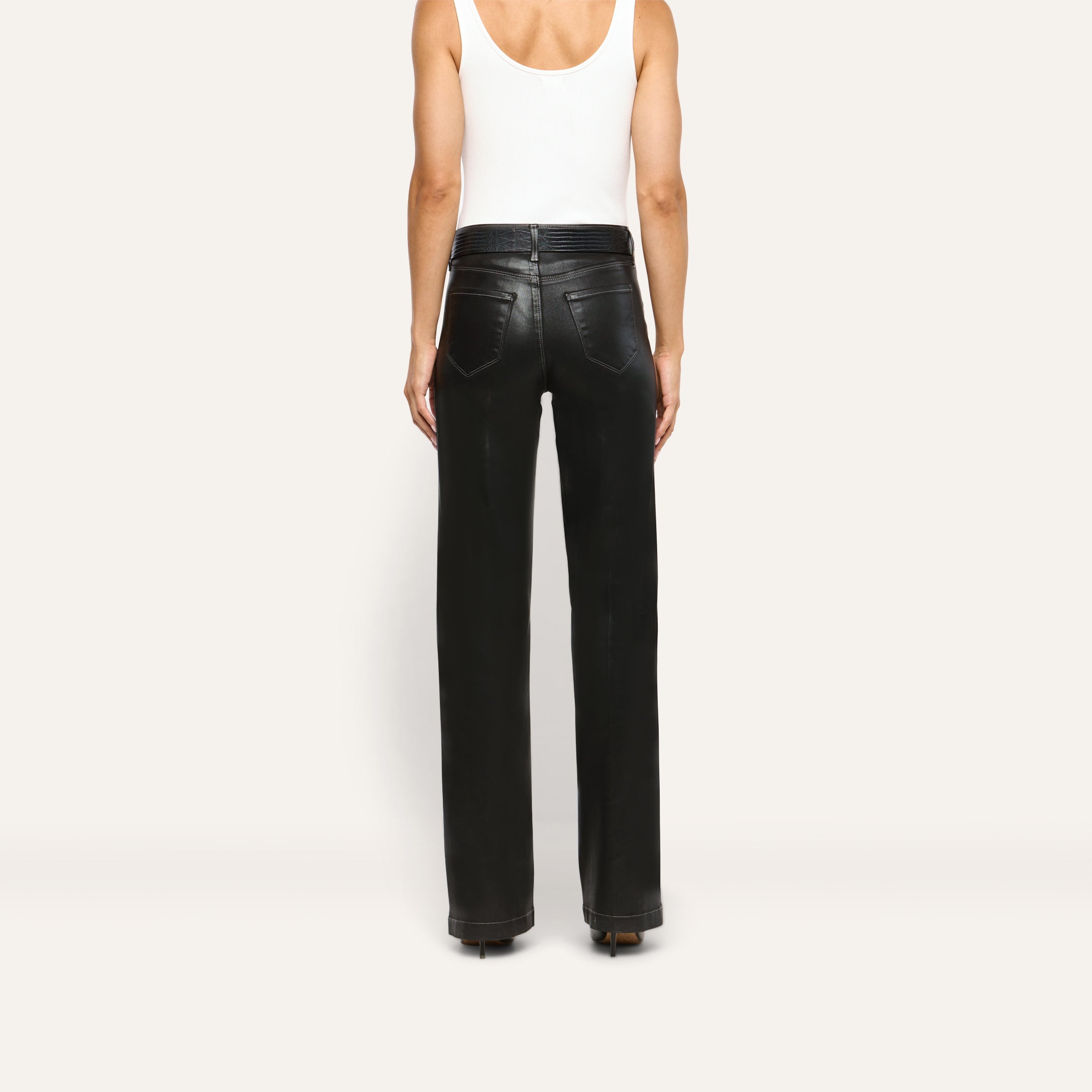 Back view of a person wearing a white tank top and Scottie Coated Wide-Leg Jean, featuring high-rise, wide-leg coated denim trousers with a belted waist.